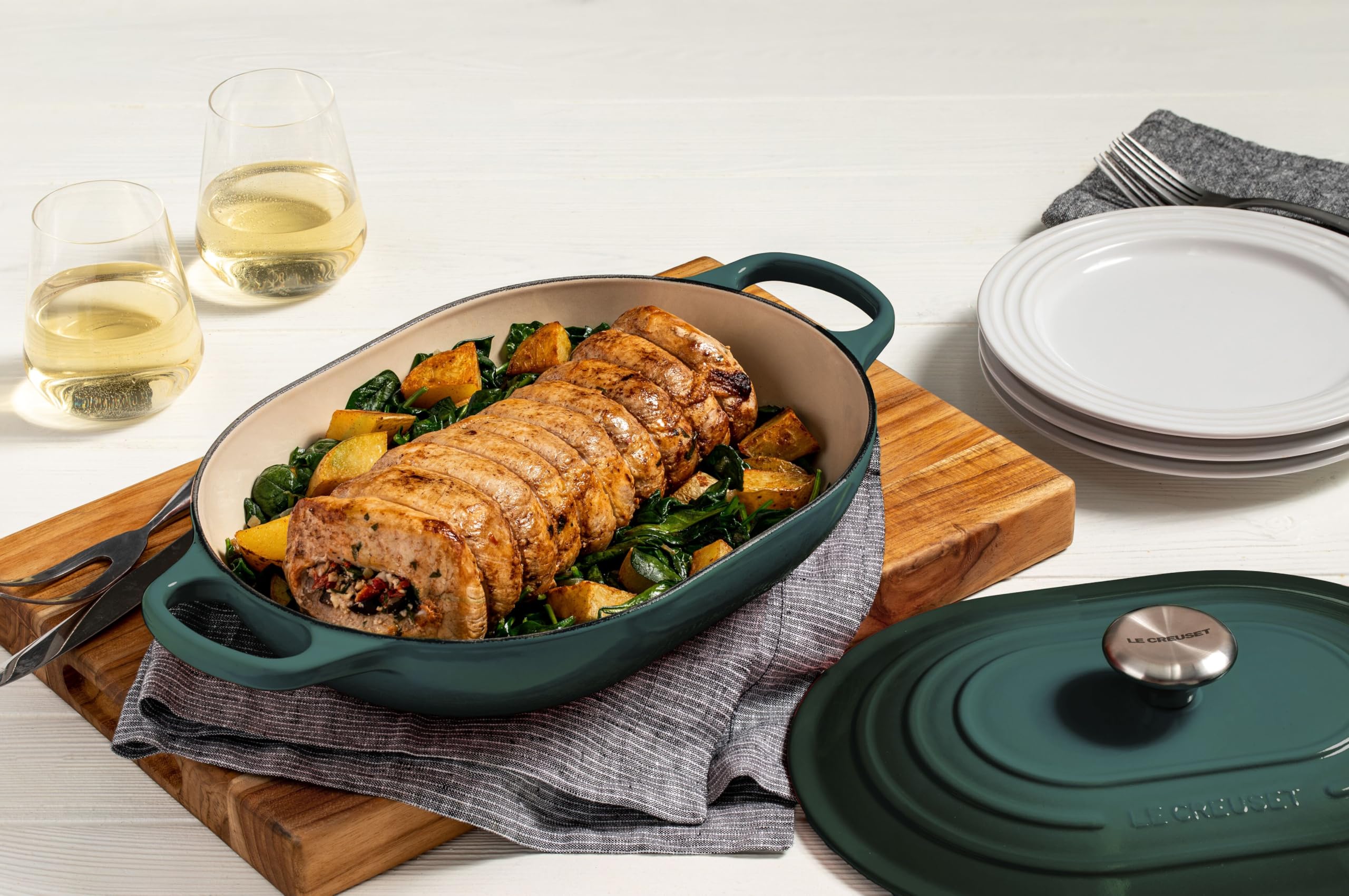 The Le Creuset casserole with a roast inside demonstrates versatile cooking and moisture retention.
