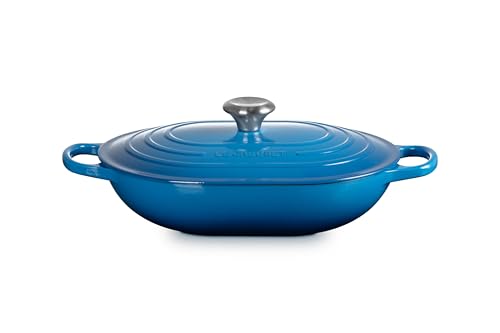 Stovetop-ready Le Creuset oval casserole with Marseille finish and ergonomic handles.