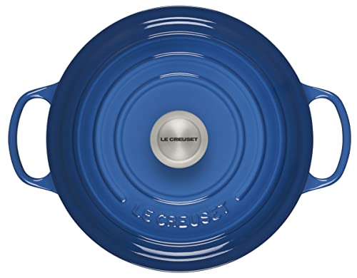 Le Creuset Signature Round Dutch Oven interior light enamel helps monitor cooking progress.