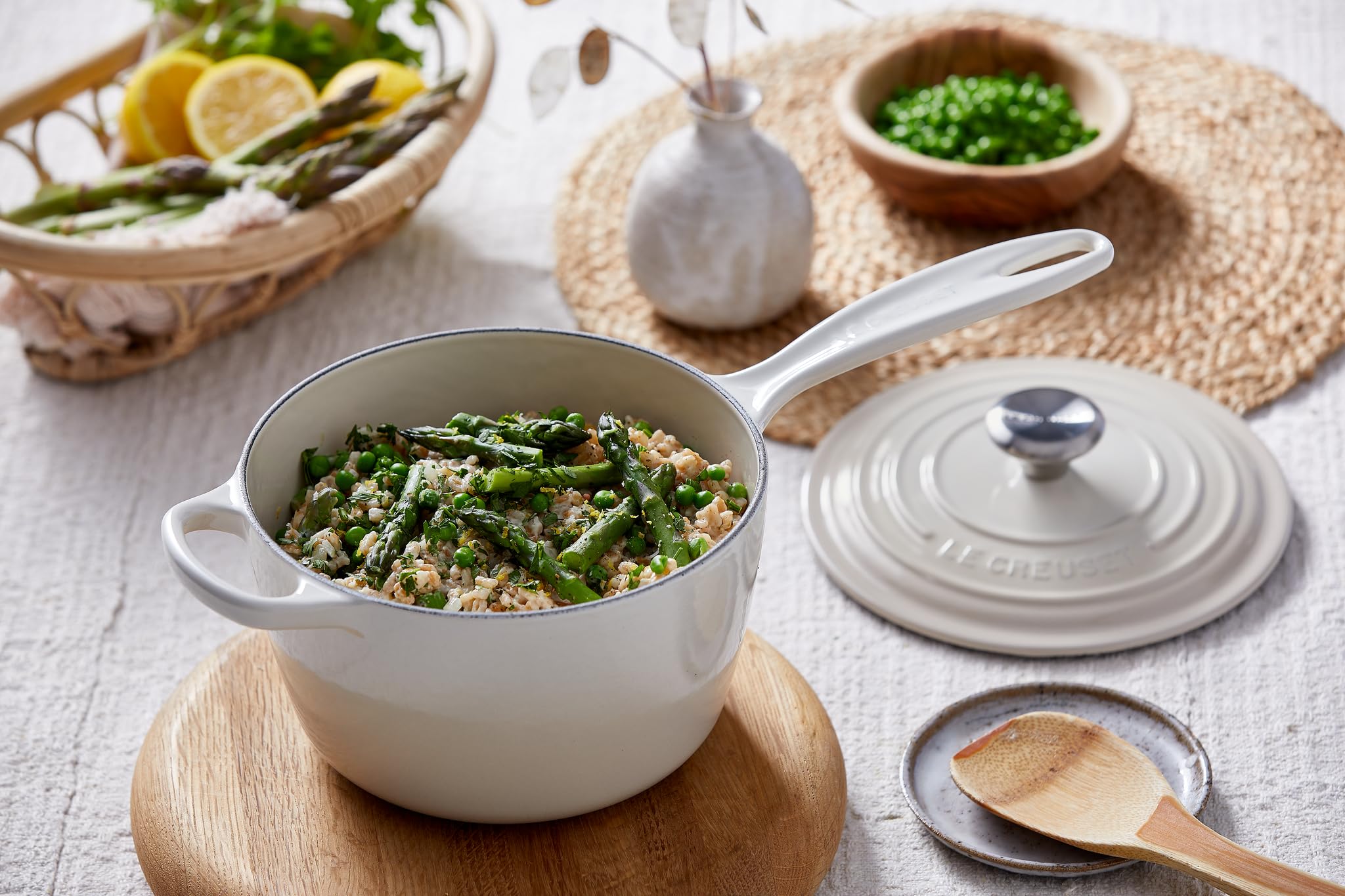 Le Creuset Signature saucepan on a cooktop highlighting versatility.