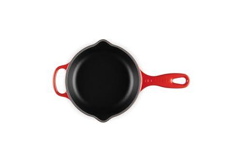 Le Creuset skillet on stove demonstrates versatile searing to sautéing.