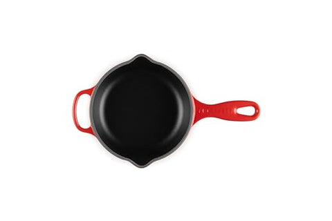 Le Creuset skillet on stove demonstrates versatile searing to sautéing.