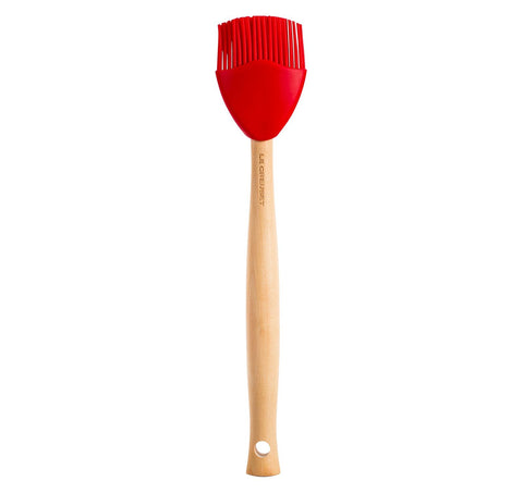 Le Creuset silicone craft basting brush in cerise with ergonomic handle for steady basting