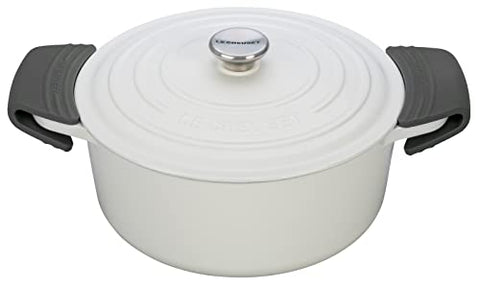 Le Creuset silicone handle grips shown in use on cookware for a safer, steadier grip.