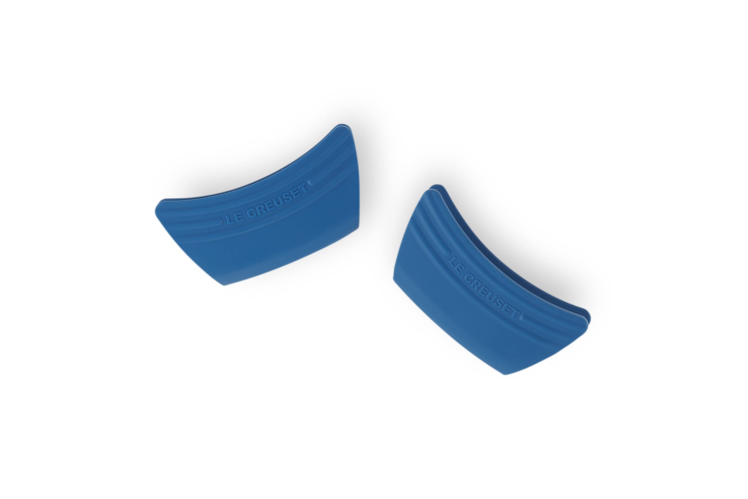 Le Creuset silicone grip set enhances handling and adds color to cookware.