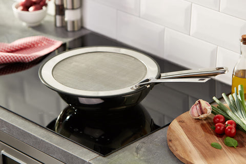 Le Creuset splatter guard with foldable handle and hanging loop for easy storage.