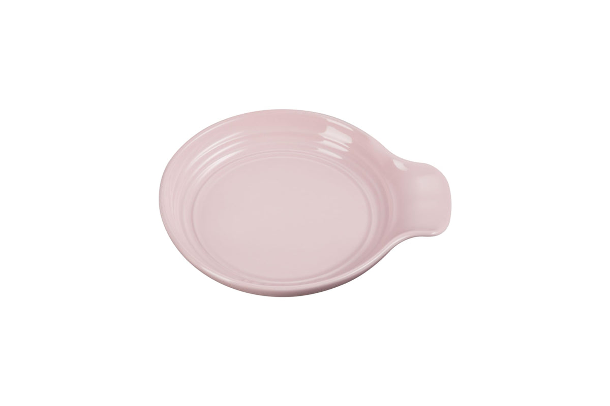 Le Creuset spoon rest round 6-inch chiffon pink keeps countertops clean during cooking.