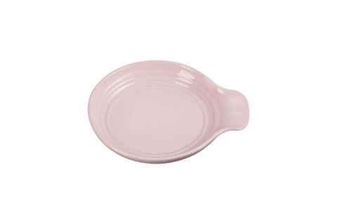 Le Creuset spoon rest round 6-inch chiffon pink keeps countertops clean during cooking.