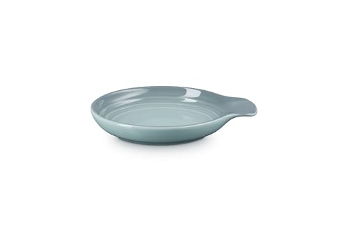 Le Creuset spoon rest on table Sea Salt glaze protects countertops during meals.