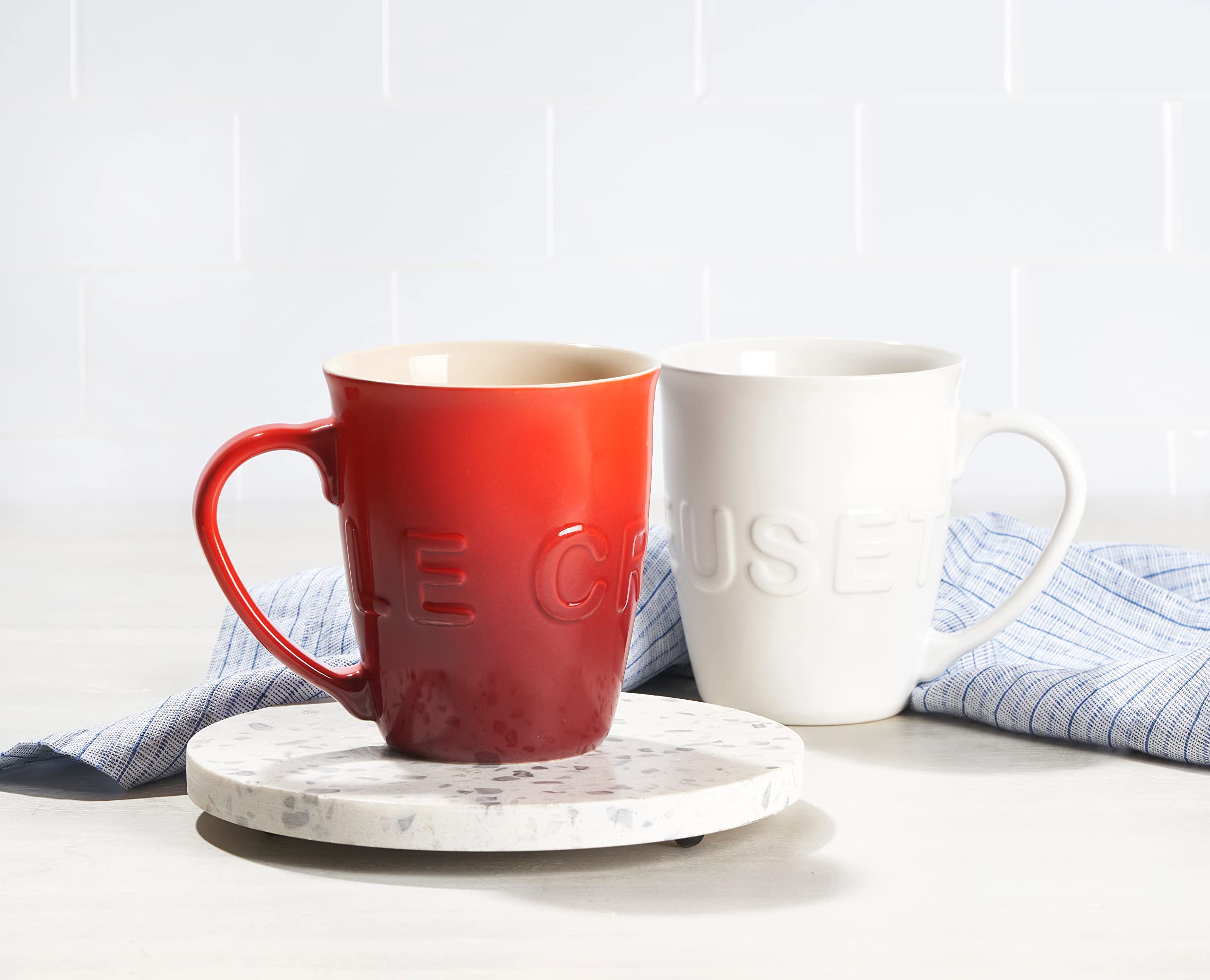 Wrap-around Le Creuset logo on Cerise mug adds bold style