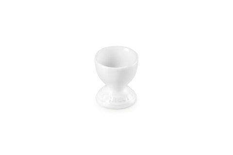 Le Creuset stoneware egg cup in white for elegant serving.
