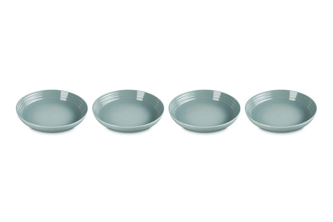 Le Creuset stoneware pasta bowls in Sea Salt, four-piece set ideal for pasta dinners.