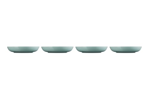 Le Creuset Sea Salt bowls arranged on a dining table setup for serving.