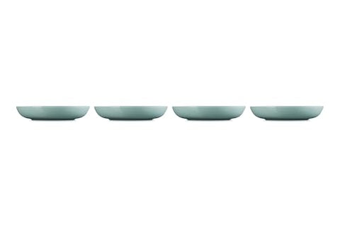 Le Creuset Sea Salt bowls arranged on a dining table setup for serving.