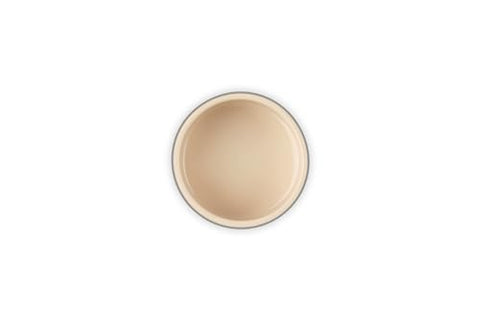 Le Creuset stoneware ramekin on table for individual servings and stylish dining.