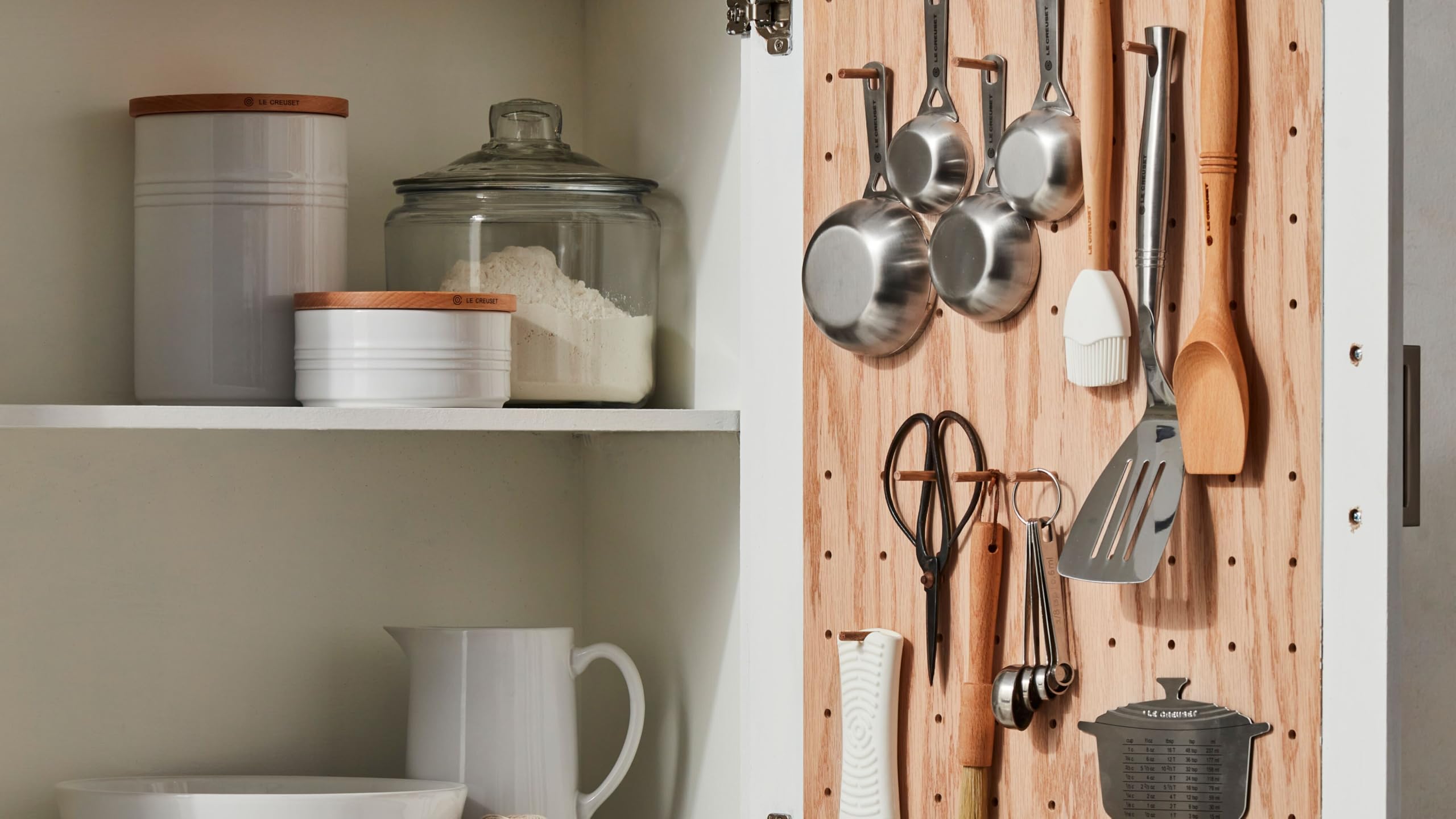 Le Creuset dining setup with cream and sugar set enhances tea time.