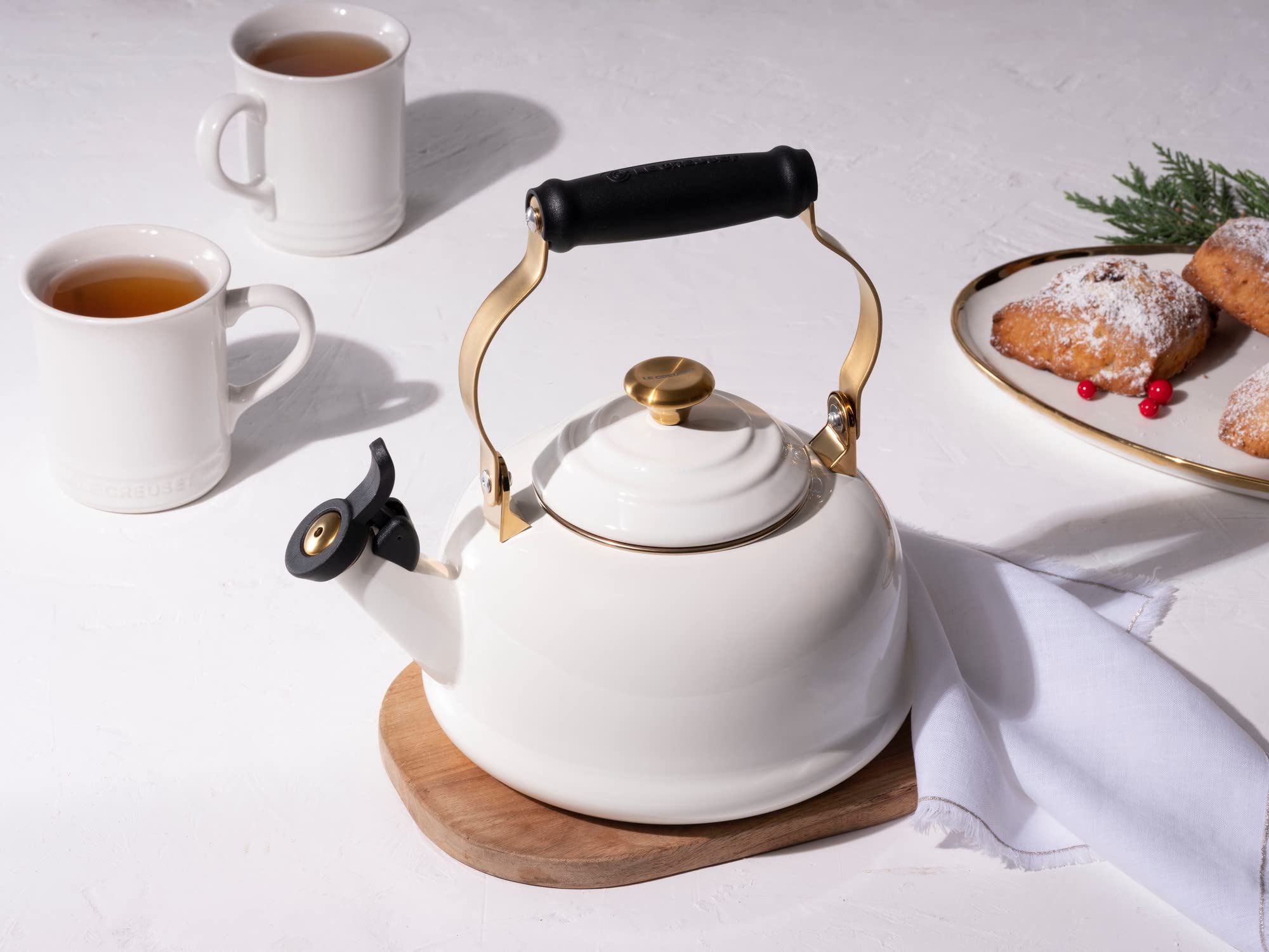 Le Creuset white enamel kettle with gold brackets adds kitchen style
