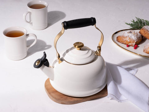 Le Creuset white enamel kettle with gold brackets adds kitchen style