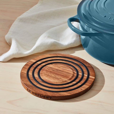 Le Creuset magnetic wooden trivet enabling oven-to-table use in a stylish kitchen
