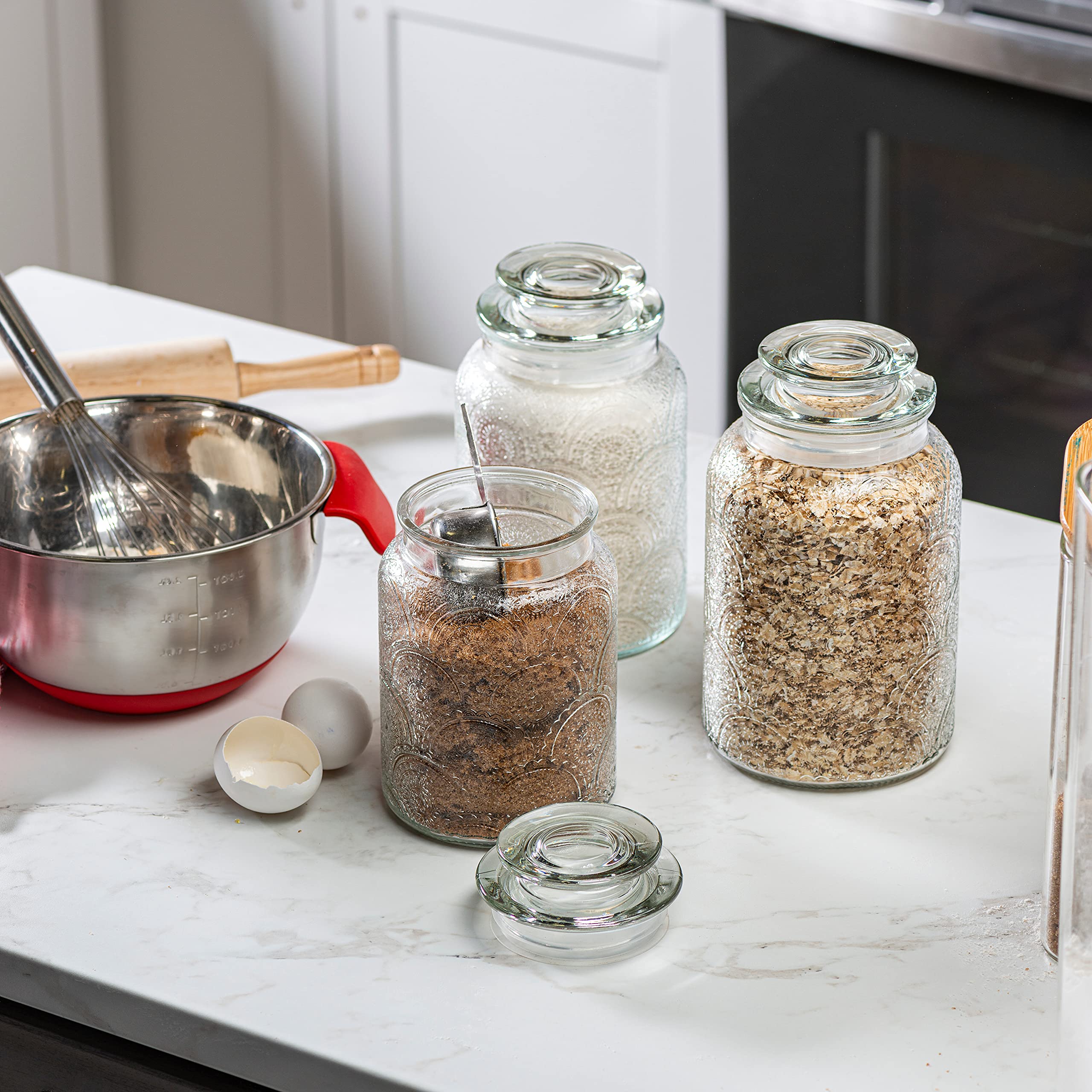 Le'raze glass canisters with airtight lids for odor-free storage.