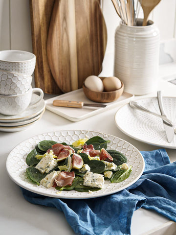 LE TAUCI plates stacked to show space-saving storage in a tidy kitchen.