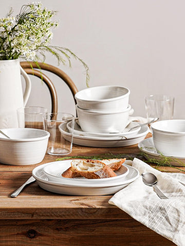 LE TAUCI Dishes Set on a dining table ready for everyday meals.
