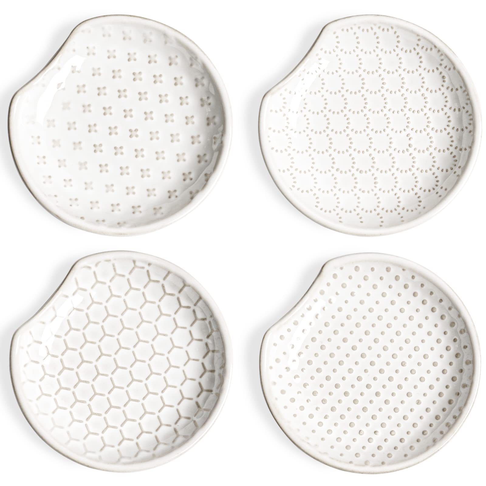 LE TAUCI spoon rest with embossed flower design sits on the stovetop to catch drips