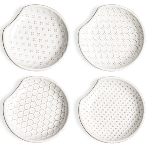LE TAUCI spoon rest with embossed flower design sits on the stovetop to catch drips