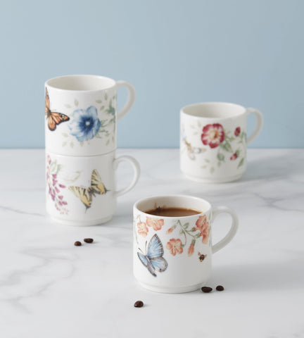 Hand holding Lenox Butterfly Meadow mug, smooth ceramic finish.