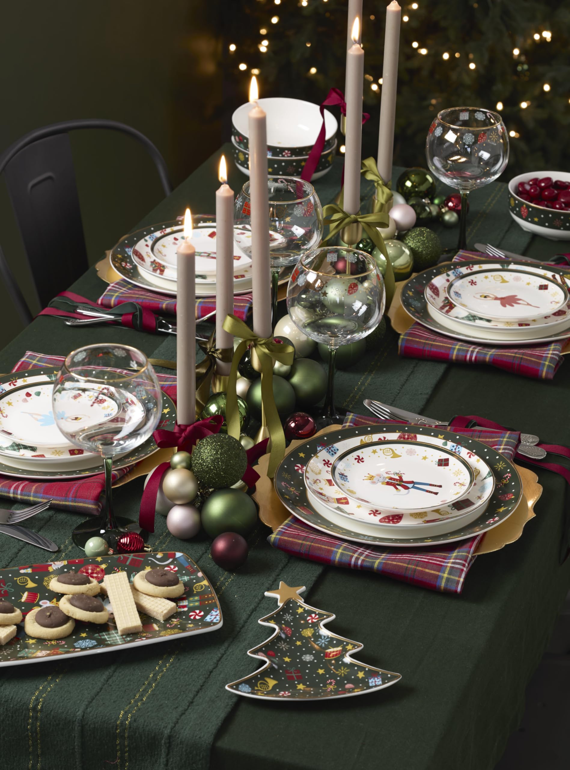 Lenox Nutcracker Ballet glassware on a holiday table with lights.