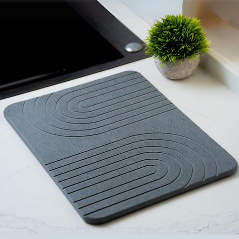 LIFSEZY stone dish drying mat absorbs water quickly on the kitchen counter.