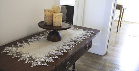 Linens, Art and Things lace runner in two-tone beige complements casual and formal meals.