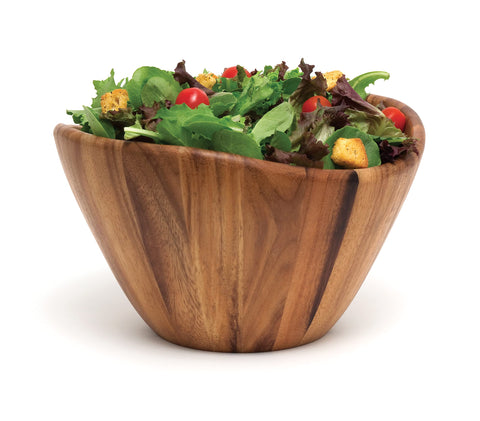 Lipper International acacia wave bowl as a centerpiece on a table.