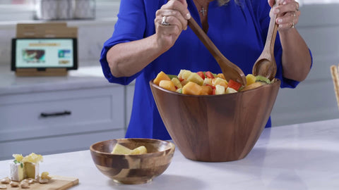 Warm brown finish of the acacia wave bowl enhances decor.