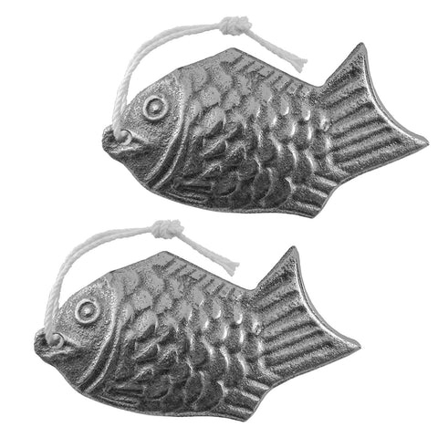 Lisol Iron Fish 2-pack on kitchen counter releasing iron into water.