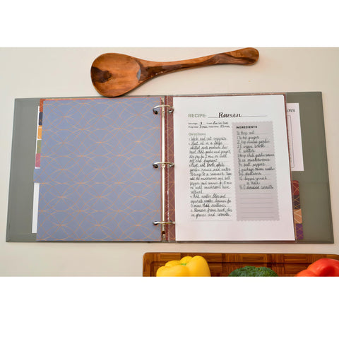 Liv'in Free sage green binder on a clean kitchen counter.