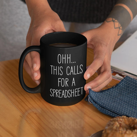 Livinges 15oz black mug with coffee on desk for productive mornings.