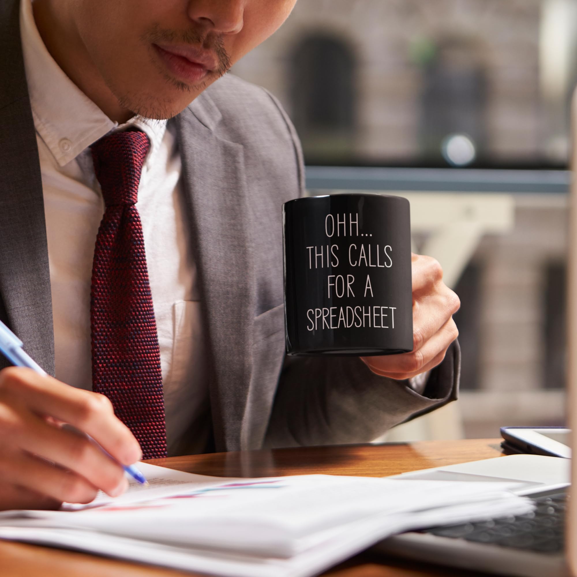 Livinges spreadsheet mug on a busy desk scene for gifting ideas.