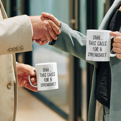 Livinges spreadsheet mug holding coffee; bold design boosts daily motivation.