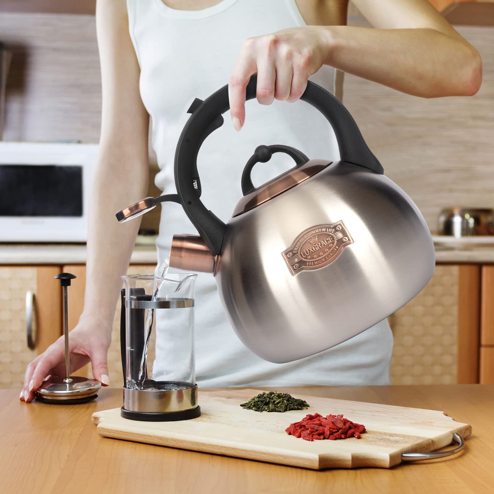 LUXGRACE teal teakettle producing visible steam and aroma as it boils.