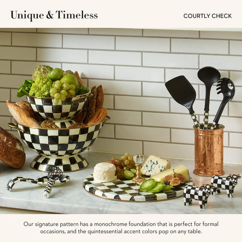 MacKenzie-Childs cheese board with clear glass knob for easy handling.