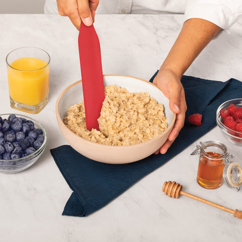 Mad Hungry 10.5-inch slotted spurtle ready to drain while stirring.
