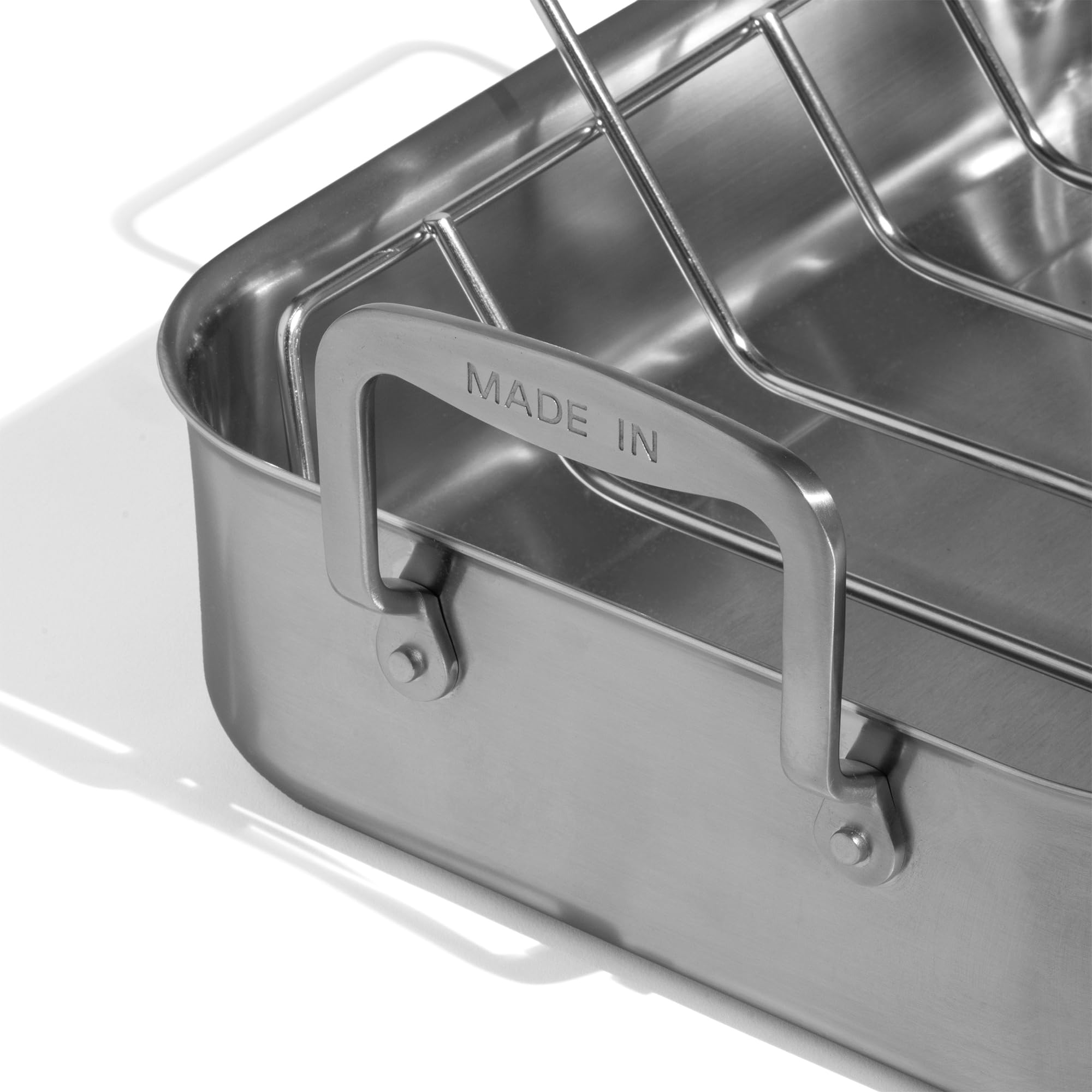 Made In roasting pan side view showcases long ergonomic handles for lifting.