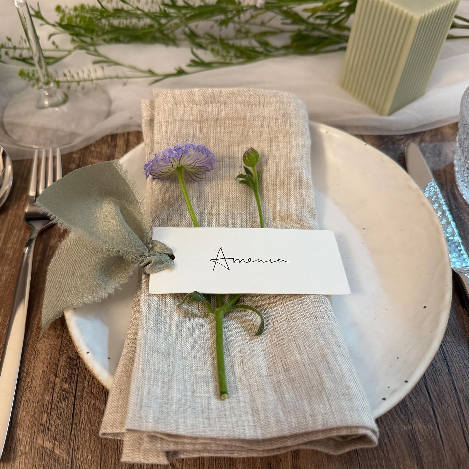 Maegmew table name cards in dusty green enhance event decor and organization.
