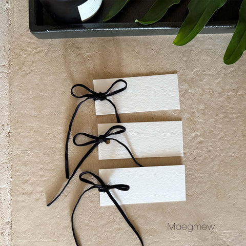 Maegmew wedding dinner cards for seating and ambiance at reception.