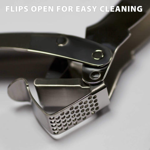 MANNKITCHEN press showing high-capacity reservoir ready to mince multiple cloves.