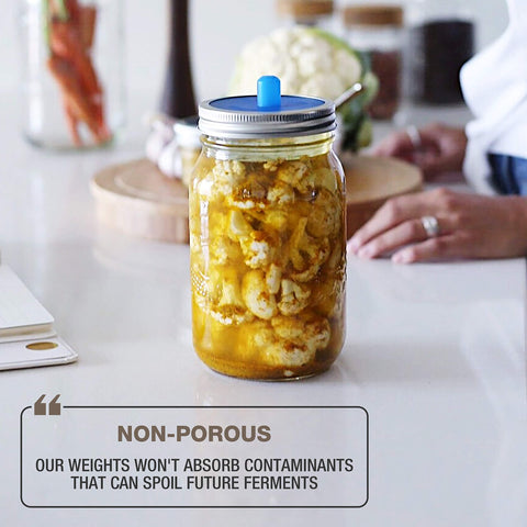 Masontops Pickle Pebble in-use during fermentation helps maintain submersion and consistent brine contact.