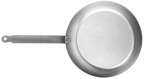 Close-up of Mauviel M'Steel iron handle on black carbon pan for a secure grip.