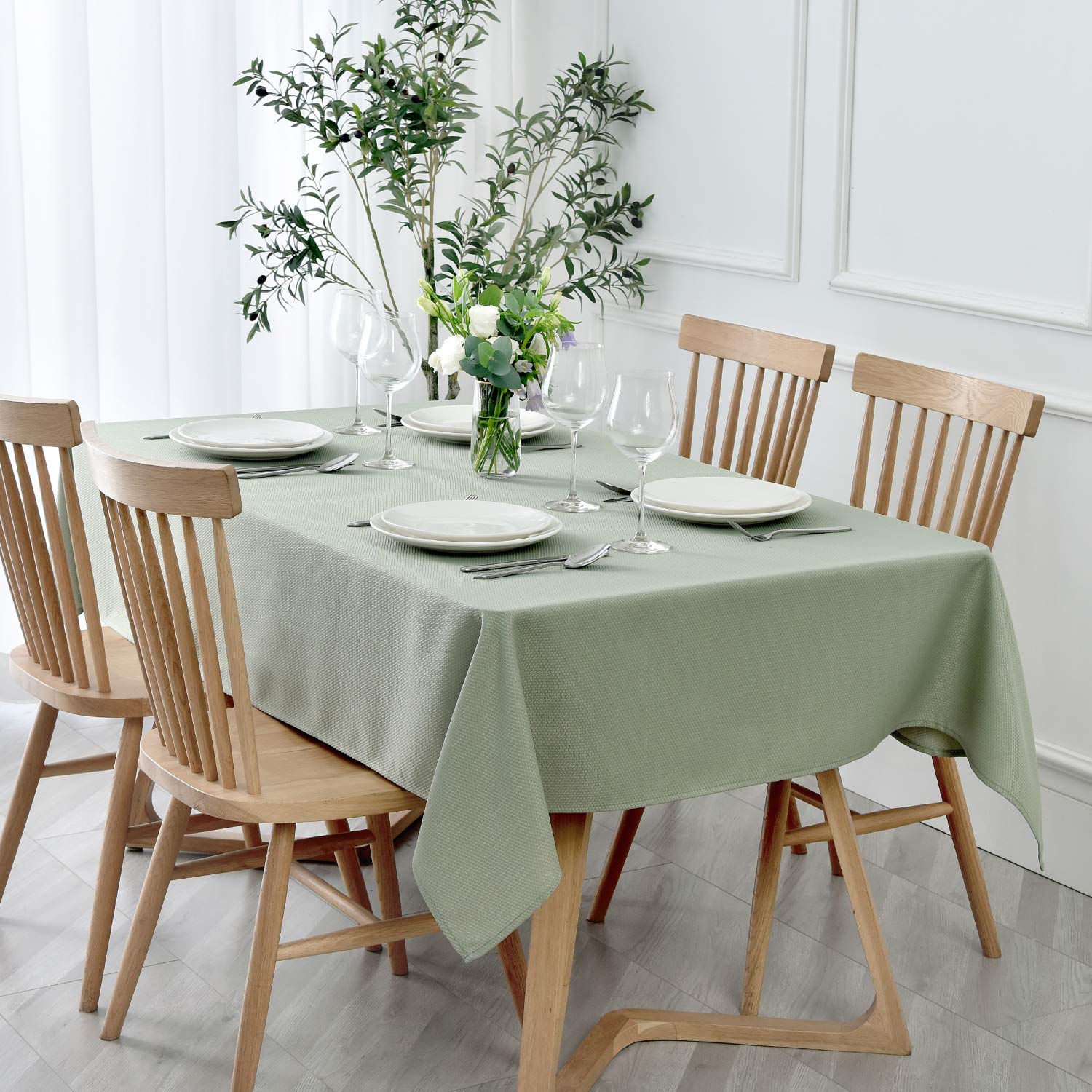 Maxmill textured rectangle tablecloth in sage green enhances dining aesthetics for elegant gatherings.