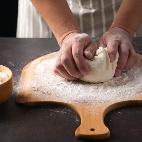 Menesia pizza peel used to transfer hot pizza from the oven